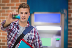 Young guy holding credit card